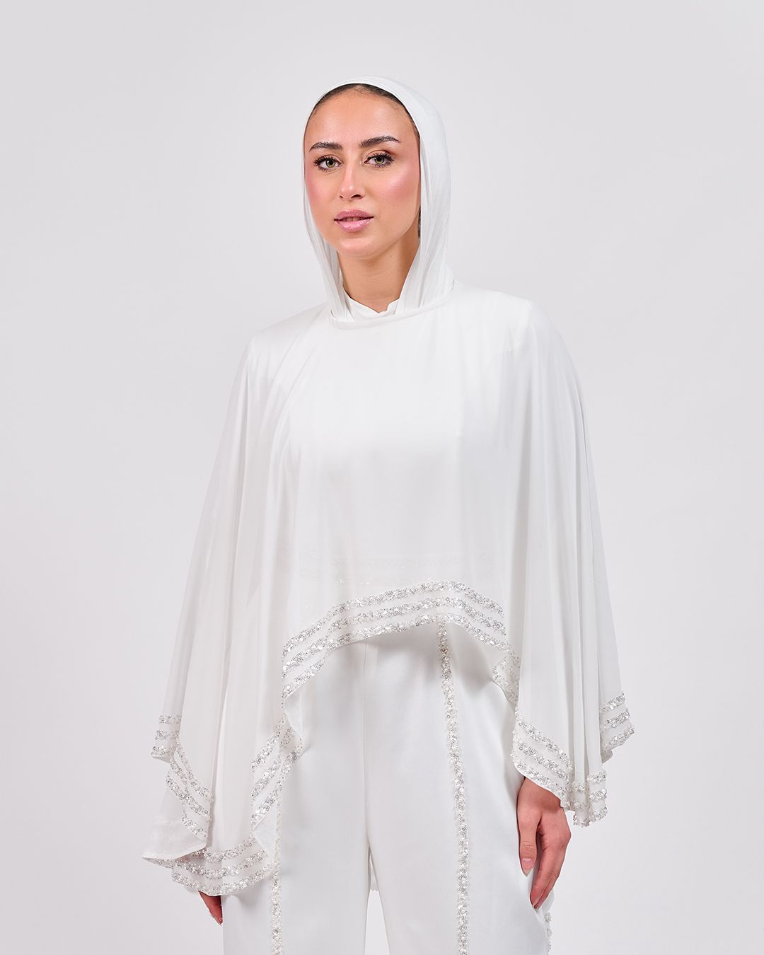 The Refined White Jumpsuit with Embroidered Cap